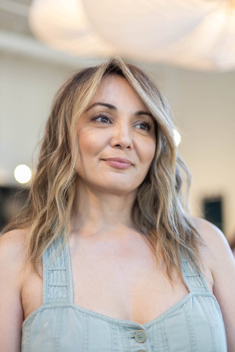Beachy bronde waves with curtain bangs by Pursuit Salon in Los Altos