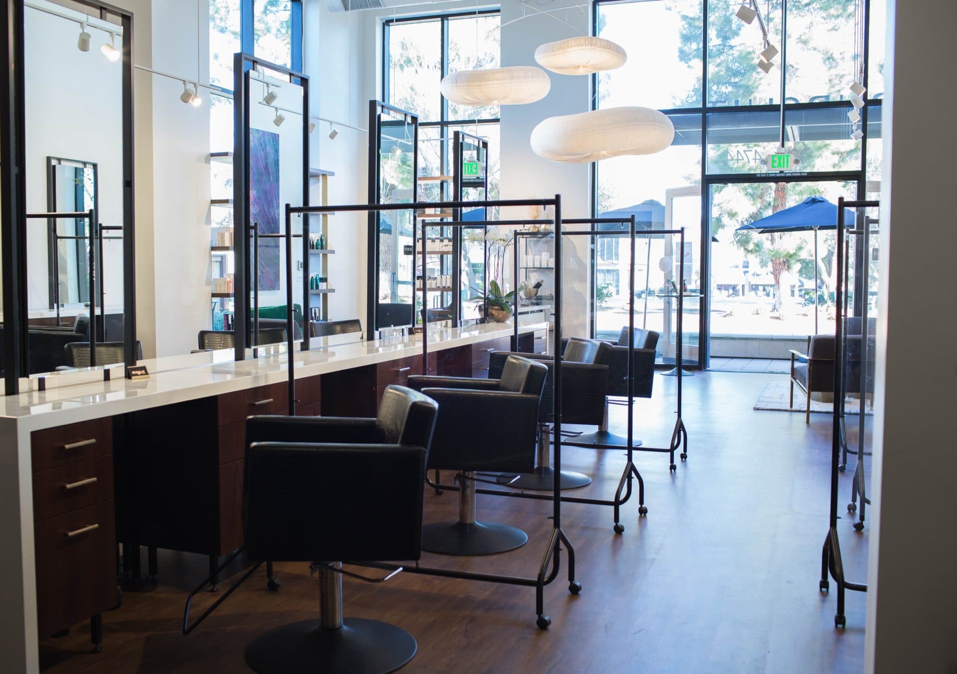 Walking into Pursuit Salon: the styling floor, tall front windows, and cloud pendant lights at 4744 W El Camino Real